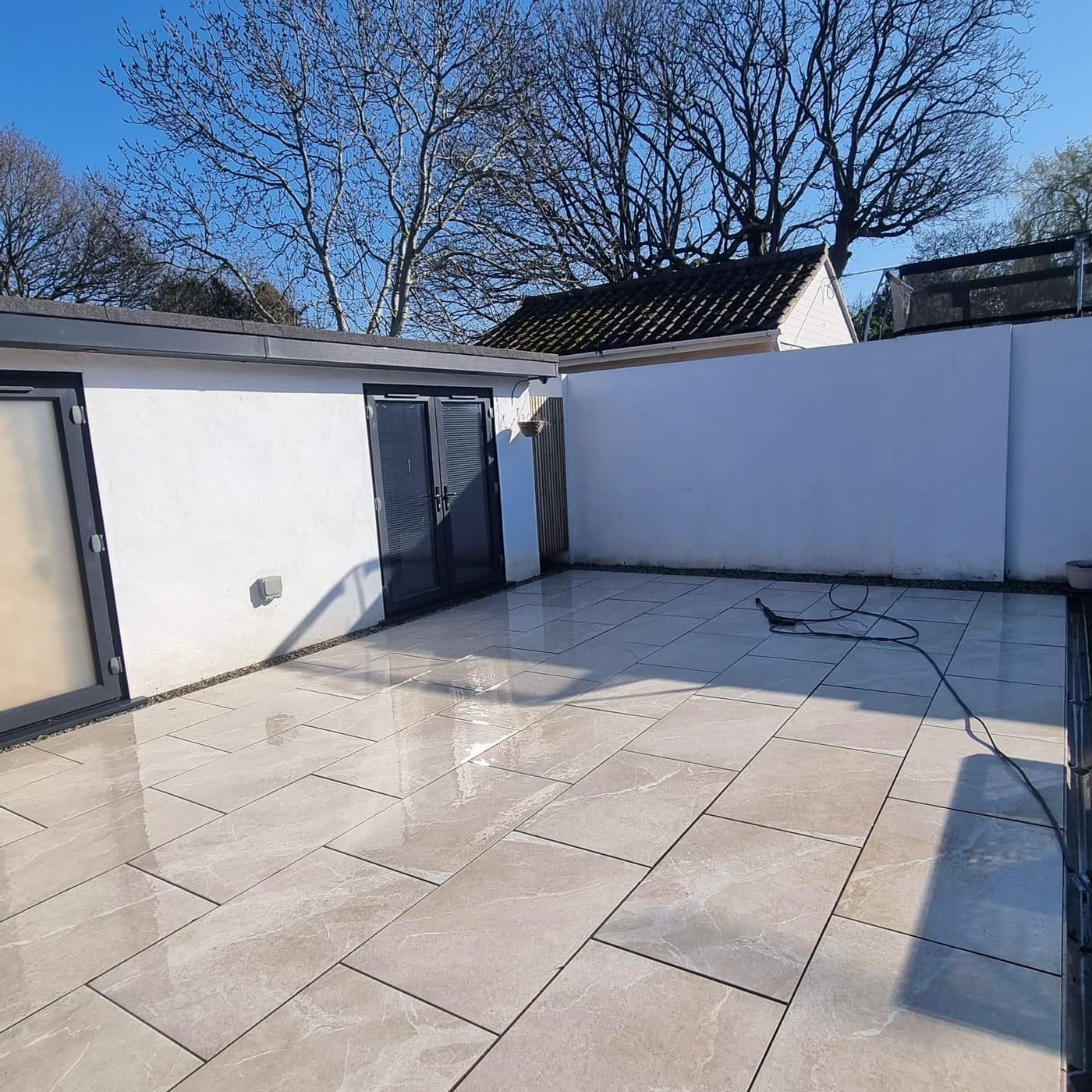 A porcelain patio cleaned to a sharp, even finish by Hydroblast Dorset