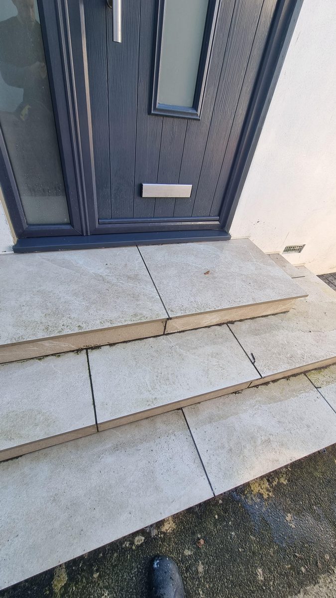 Porcelain patio in Kinson before cleaning, moss in the joints